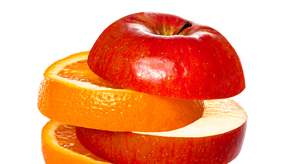 Slices of apple and orange are layered to show their differences