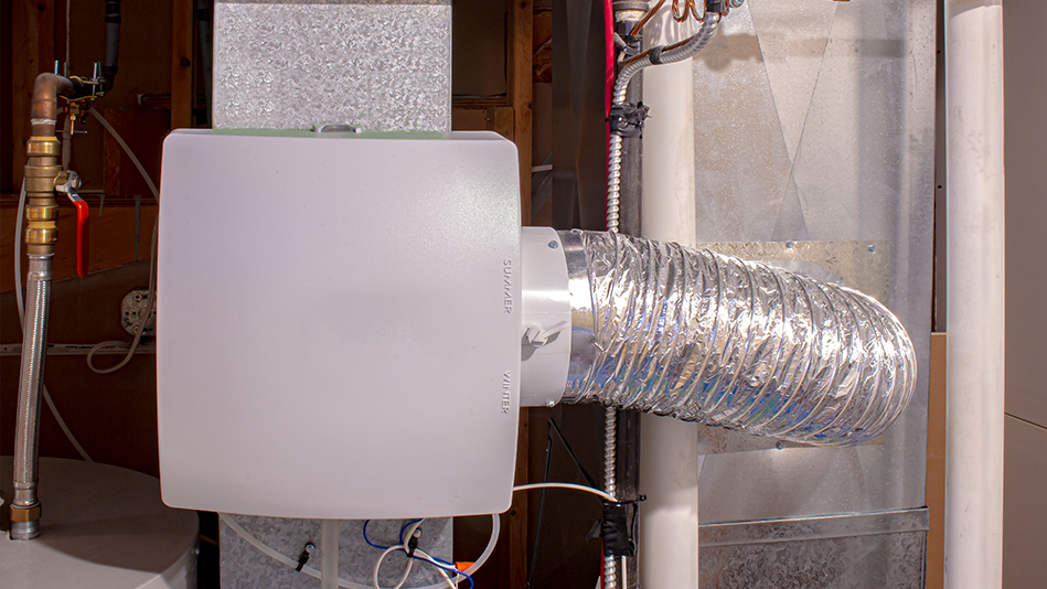 A gray furnace humidifier attached to a gray furnace 