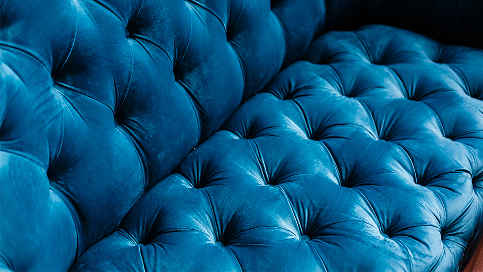 Closeup of a tufted cerulean couch