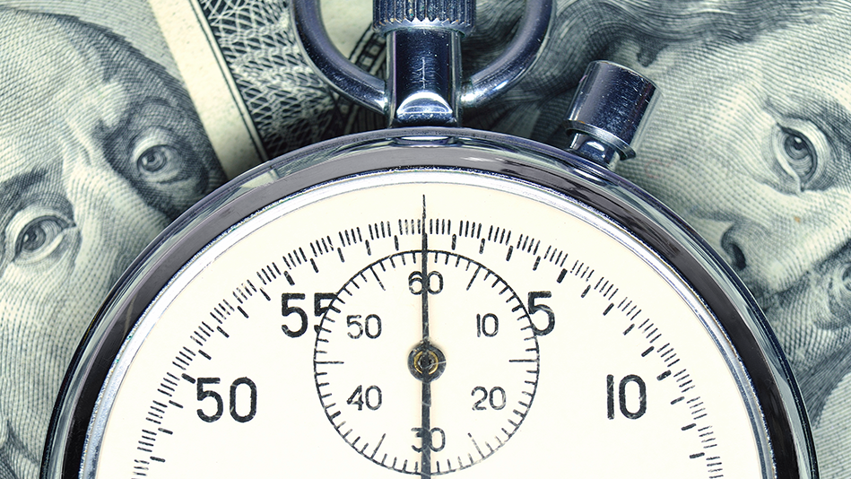 Closeup of a stopwatch resting on American cash