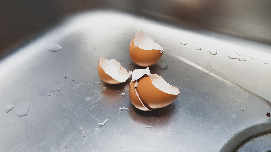 Broken eggshells sit off to the side in a sink