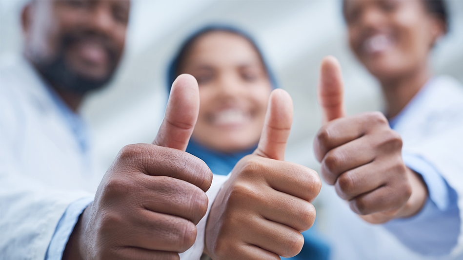 Three people give thumbs up