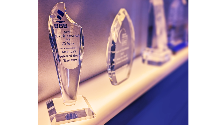 APHW's Torch Award from the BBB stands upon a shelf with multiple other awards