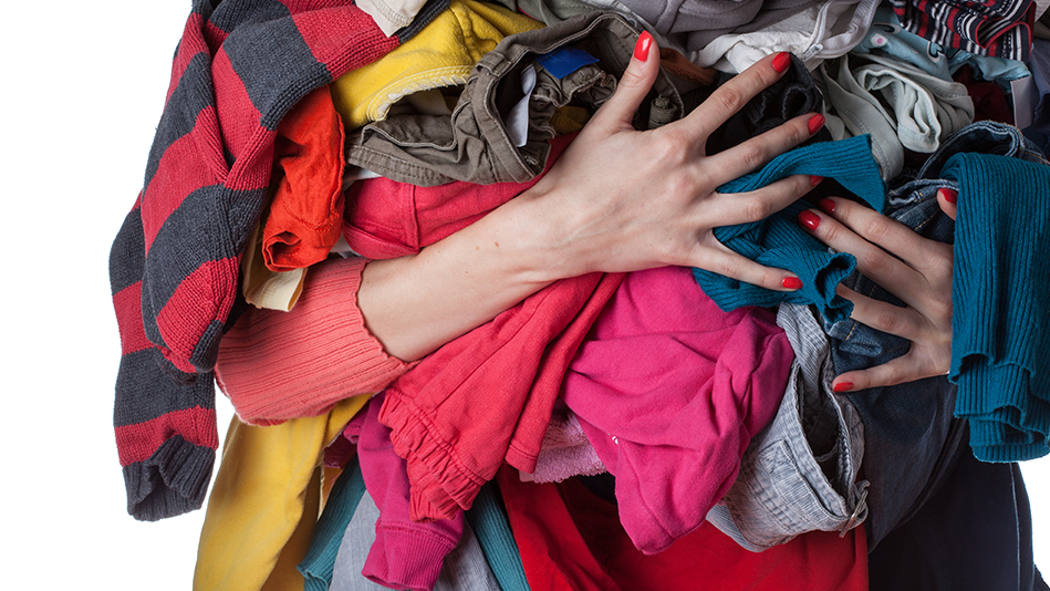 A woman's arms holding way too much laundry at once