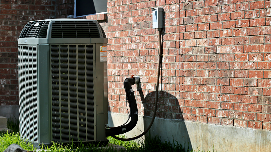 An air conditioner power source is connected to the outside wall of a home