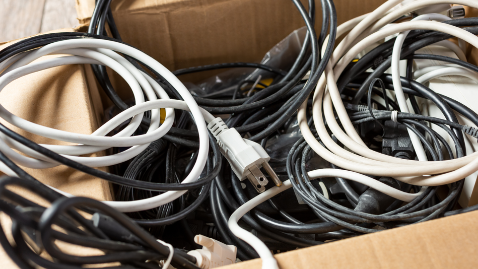 A bundle of electrical cords in a cardboard box