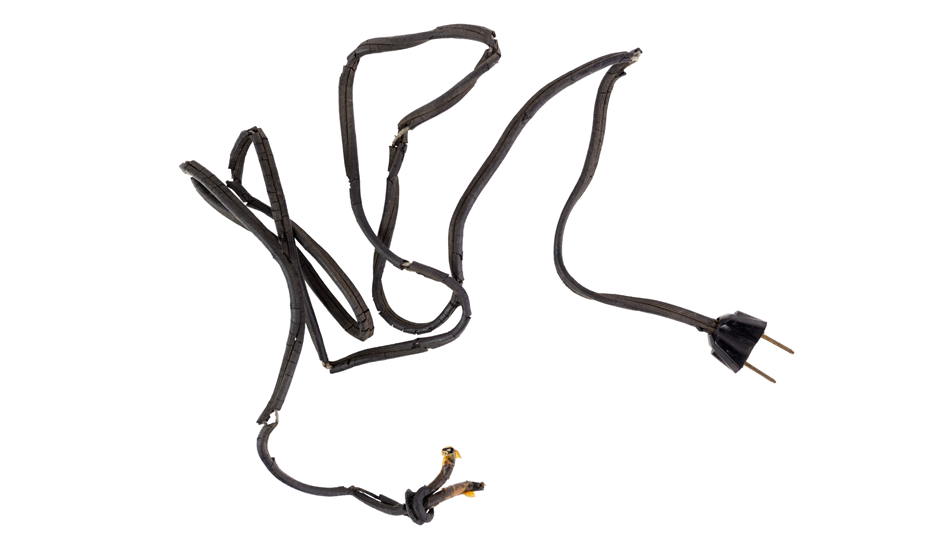 An unsafe, black extension cord is frayed at the edges