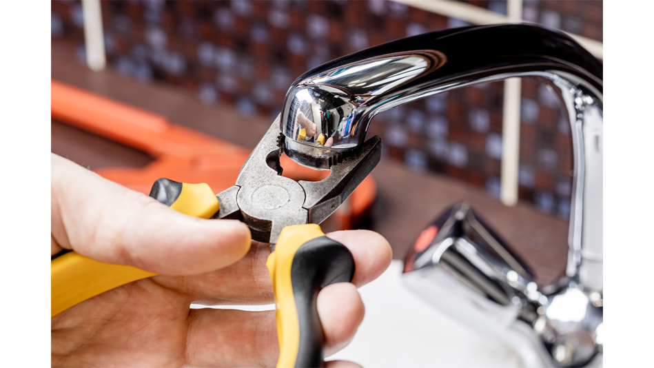 Pliers are used to unscrew an aerator from a faucet