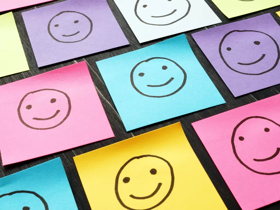Smiley faces on assorted colored sticky notes