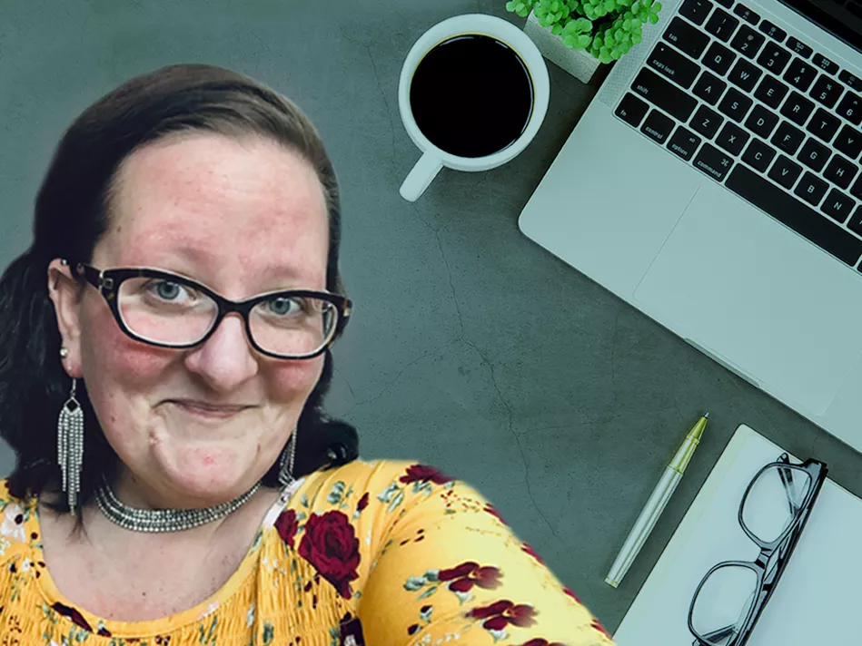 Krista Coulter in a floral top in front of an aerial view of a computer, coffee mug, plant, journal, pen, and glasses