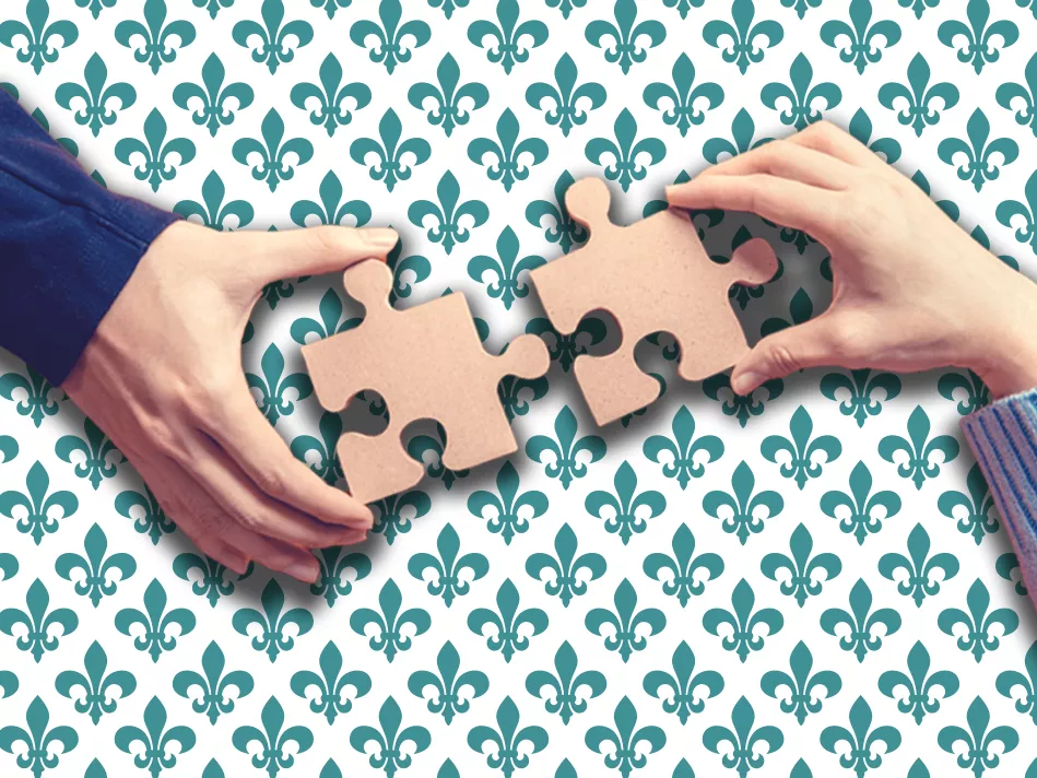Two white hands on opposite sides putting 2 puzzle pieces together