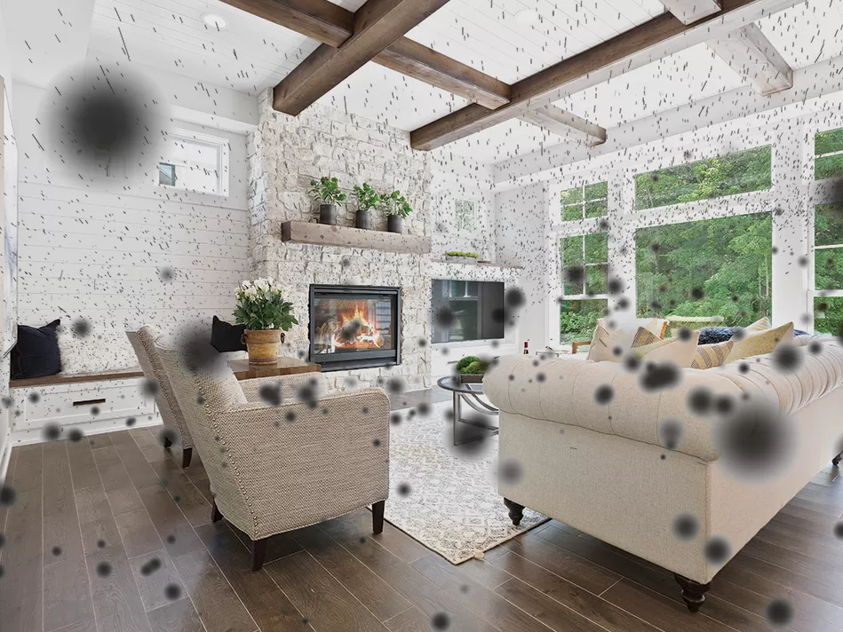 An open monochromatic brown living room with black spores of various sizes in the air throughout