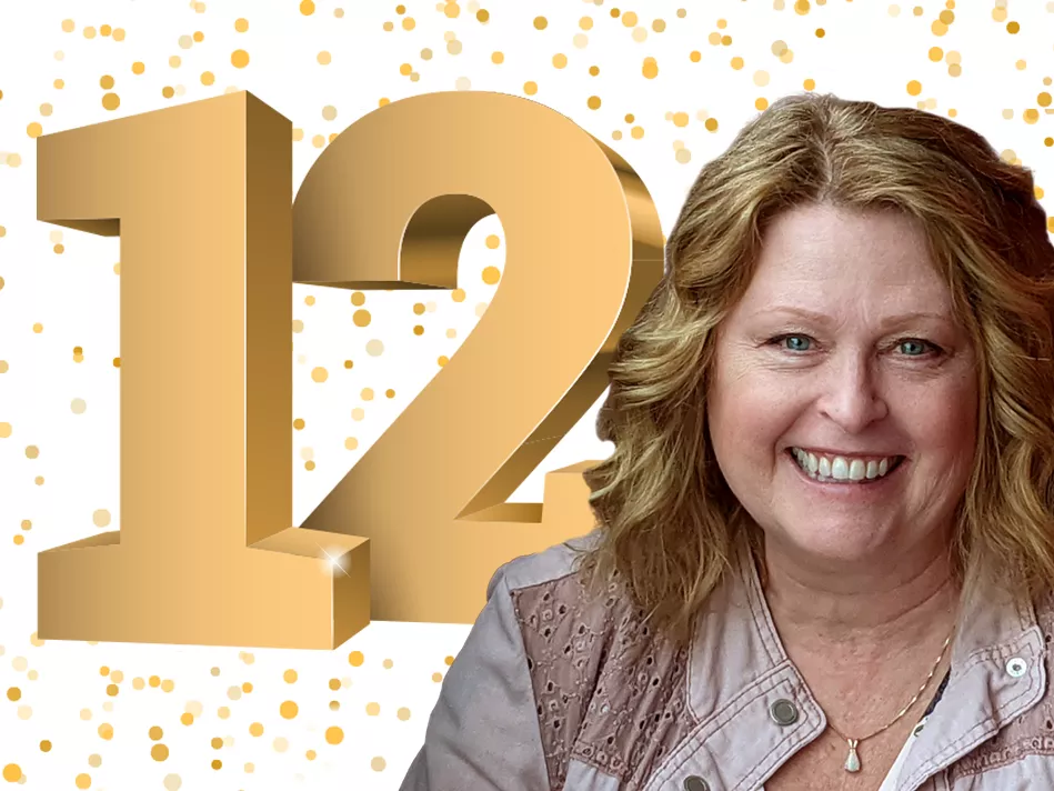 Gold confetti falls in the background while a white woman grins in front of the number 12